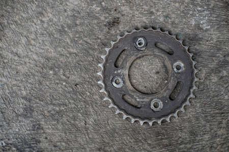 Motorcycle gear that is covered in oil and used for a long timeの写真素材