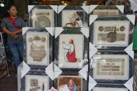 Yogyakarta, Indonesia, June 04, 2017. Religious-themed wall hangings such as Quran verses and images of Jesus Christ are sold on the side of Malioboro streetのeditorial素材