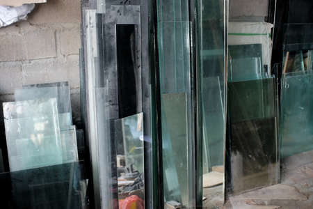 Pieces of glass of various sizes and thickness in a workshop that will be reusedの写真素材