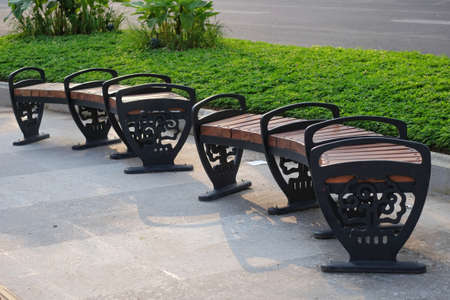 Park chairs in public spaces on a clean pedestrian path.の写真素材