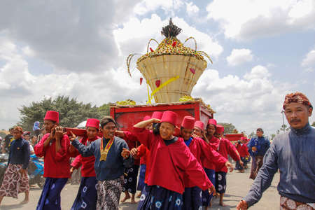 Yogyakarta, Indonesia, Oct 5, 2014. Abdi dalem carries Gunungan Lanang in the Great Grebeg tradition event conducted by the Yogyakarta Palace. After praying for Gunungan, people will fight over them.のeditorial素材