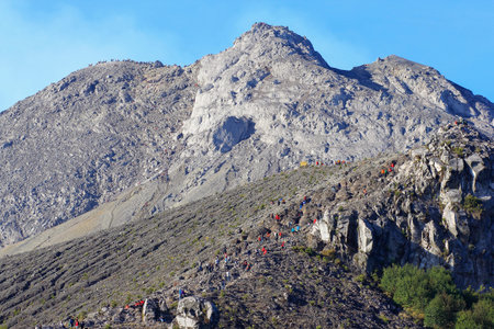Boyolali, Indonesia, Oct 25, 2014. Mass climbing to the summit of Mount Merapi and the line of...