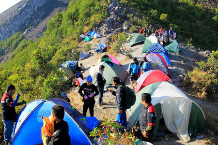 Boyolali, Indonesia, Oct 25, 2014: Mount Merapi climbers erect dome tents on the hiking trail to the summit because of the crowded visitors.のeditorial素材