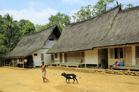 Tasikmalaya, Indonesia, July 24, 2015. Residents pass in front of the Kampung Naga traditional house which is still a stage and made of wood and bamboo.のeditorial素材