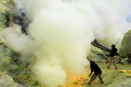 Banyuwangi, Indonesia, May 27, 2015. Sulfur miners in the Ijen crater. The health condition of miners is very risky because it is not equipped with adequate safety standard equipment.のeditorial素材