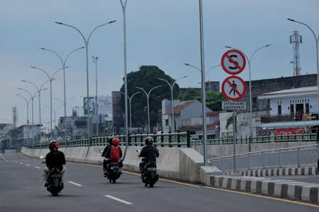 Yogyakarta, Indonesia, April 26, 2020. Motorized vehicles pass on a quiet street due to the impact of a pandemic coronavirusのeditorial素材
