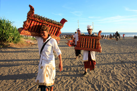 Yogyakarta, Indonesia, March 3, 2018. Balinese in traditional clothing who are Hindus walk while carrying traditional musical instruments after the Melasti religious event on Parangkusumo beachのeditorial素材