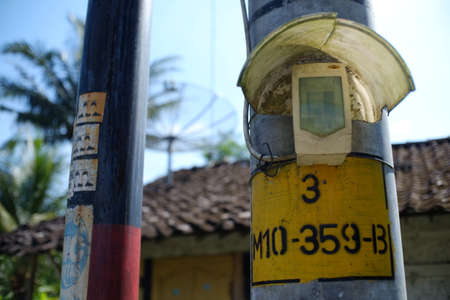 Central Java, Indonesia, April 8, 2019. The ignition switch for lighting street lights attaches to electricity poles in a village in Magelang.のeditorial素材