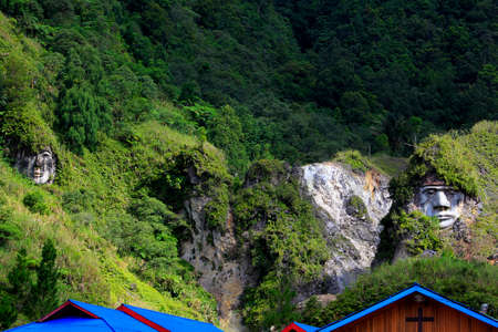 North Sulawesi, Indonesia, June 17, 2015. Carved faces of Toar Minahasa ancestral figure in Bukit Kasih complex. Toar is believed to be one of the people who first set foot on the land of Minahasa.のeditorial素材