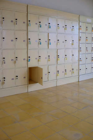 Wooden locker cabinets for storing personal belongings are safe because they are equipped with a lock on each locker.の写真素材