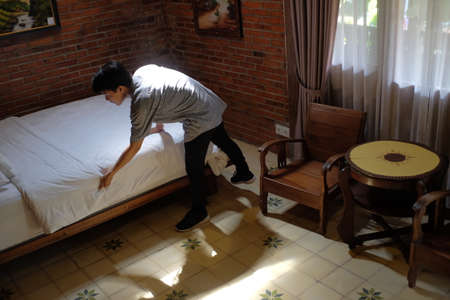 Yogyakarta, Indonesia, July 3, 2019. Room boy tidied up the bedroom of an ethnic-style hotel.のeditorial素材