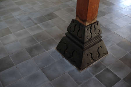 Umpak, the foundation above the land surface that supports the load or pole structure of the house in the traditional Javanese Joglo house building.の写真素材