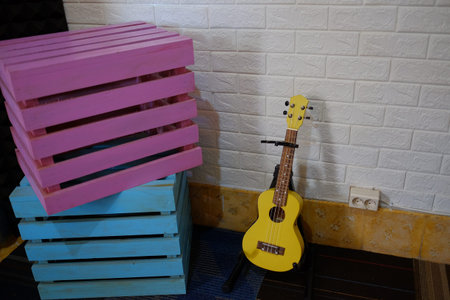 Yogyakarta, Indonesia, Oct 26, 2021. Ukulele stringed instrument, placed on a floor in a simple...