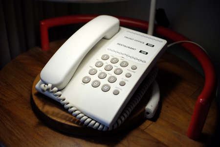 Telephone in the hotel room to call the front office and restaurant section.の写真素材