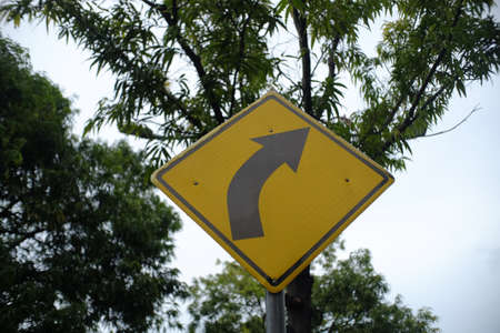A traffic sign that informs you if the road ahead is turning slightly to the right.の写真素材