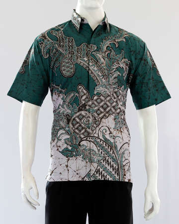 Men's green tosca batik shirt with short sleeves, looks dashing and neat, worn for formal events.の写真素材