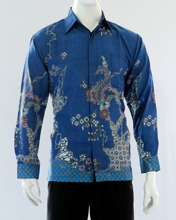 Men's blue batik shirt with long sleeves, looks dashing and neat, worn for formal events.の写真素材