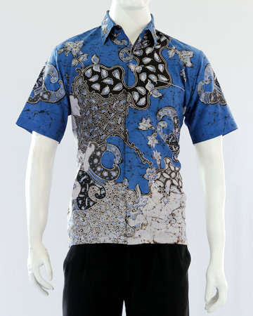 Men's blue batik shirt with short sleeves, looks dashing and neat, worn for formal events.の写真素材