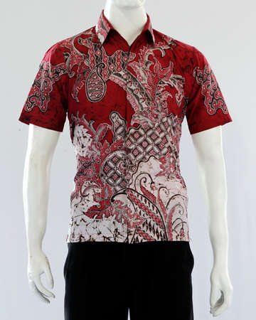 Men's red batik shirt with short sleeves, looks dashing and neat, worn for formal events.の写真素材
