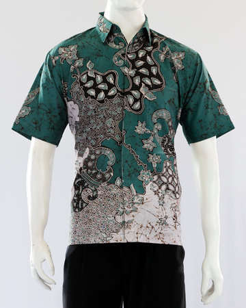 Men's green tosca batik shirt with short sleeves, looks dashing and neat, worn for formal events.の写真素材
