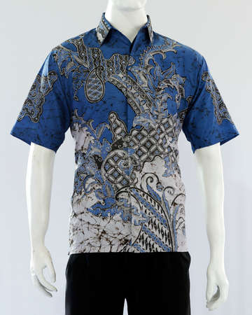 Men's blue batik shirt with short sleeves, looks dashing and neat, worn for formal events.の写真素材