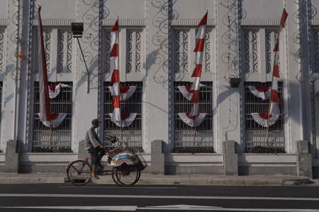 Pedicab drivers pass through European-style historic buildings in the city of Yogyakarta, Indonesia, August 12, 2108. Yogyakarta is known as a city of culture that still preserves traditional values.のeditorial素材