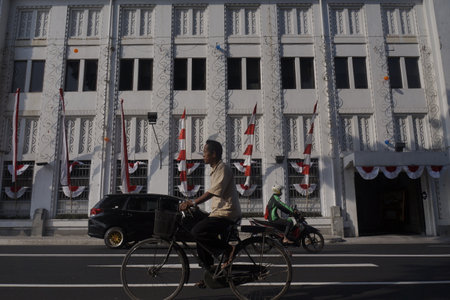Residents use bicycles passing in front of European-style historic buildings in the city of Yogyakarta, Indonesia, August 12, 2108. Yogyakarta is one of the cities that developed Javanese culture.のeditorial素材