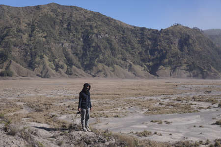 East Java, Indonesia, Aug 16, 2018. A man stands alone in the Mount Bromo caldera. Active volcanoes in East Java Indonesia with a caldera area of 10 Kilometers square.のeditorial素材