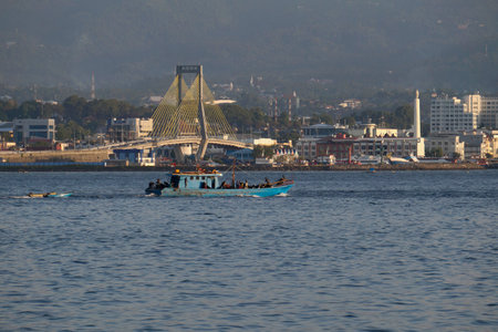 North Sulawesi, Indonesia, Aug 20, 2018. Fishing boats go to sea in the urban setting of Manado.のeditorial素材