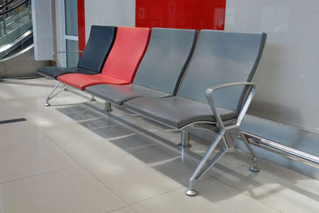 Waiting chairs in a room with bright lighting.の写真素材