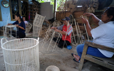 Yogyakarta, Indonesia, March 6, 2022. Rattan craftsmen are  making containers in their workshop.のeditorial素材