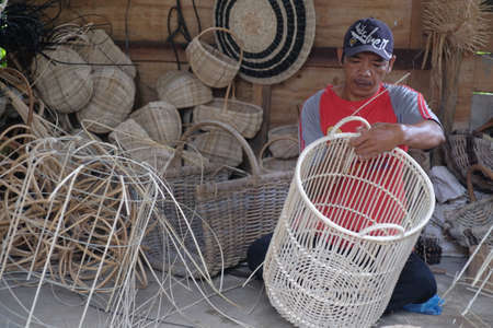 Yogyakarta, Indonesia, March 6, 2022. Rattan craftsmen are  making containers in their workshop.のeditorial素材