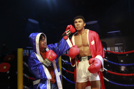 Singapore, Feb 25, 2015. Visitors pose with world-class boxer wax statue of Muhammad Ali at the Madame Tussauds Museum.のeditorial素材