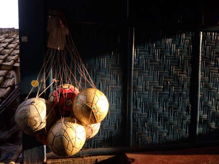 The strong afternoon sun shone on the balls hung on the walls of the house.の写真素材