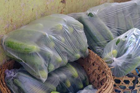 Cucumbers are packaged in plastic, ready to be sold to buyers.の写真素材