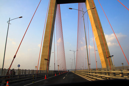 The driver's perspective when crossing the Suramadu bridge, a sturdy building construction with a barrier-free asphalt road.の写真素材