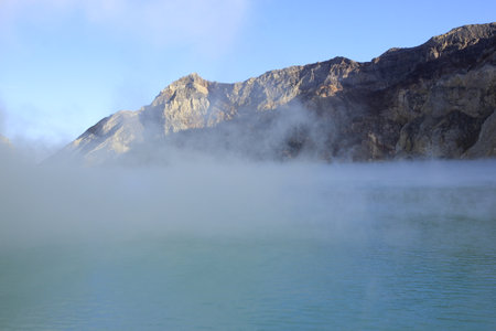 The haze covers surface of Ijen crater lake which is blue and has a high level of acidity due to the sulfur content.の写真素材