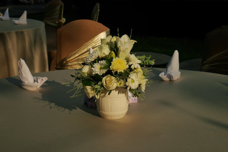 Flowers in a vase placed on a round table as a beautiful decorationの写真素材
