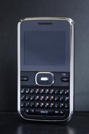 Mobile phone with outdated technology isolated on black backgroundの写真素材
