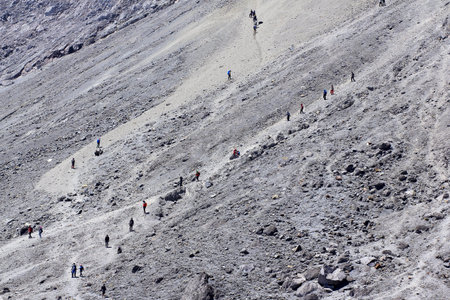 Climbers pass the sandy climbing route to the top of Mount Merapi, with an average slope of 70...