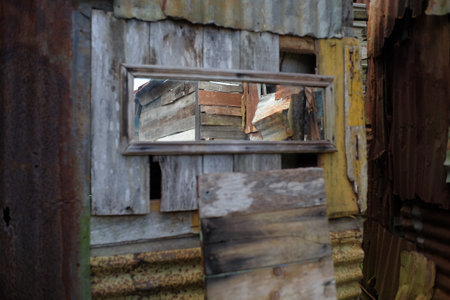 A mirror in an outdated building with rusty zinc wallsの写真素材