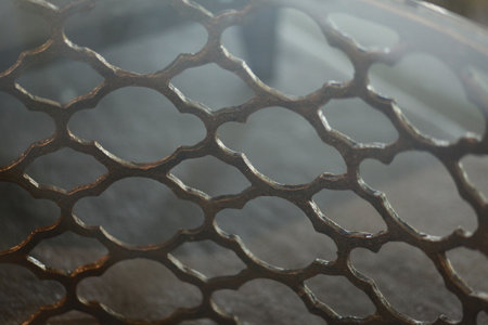 The dull but sturdy looking iron mesh element is used as an industrial style background.の写真素材