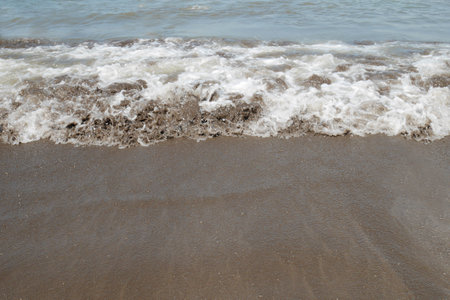 The coastline, boundary between sand and wave foam.の写真素材