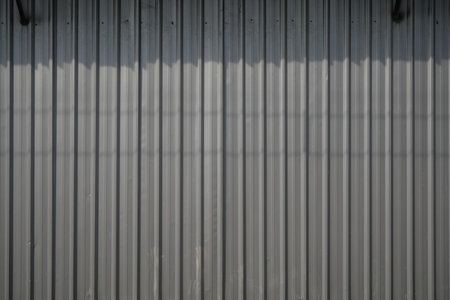 Steel plates with vertical line patterns can be used as visual backgrounds for industrial themes, modern construction, and as supporting promotional design assets.の写真素材
