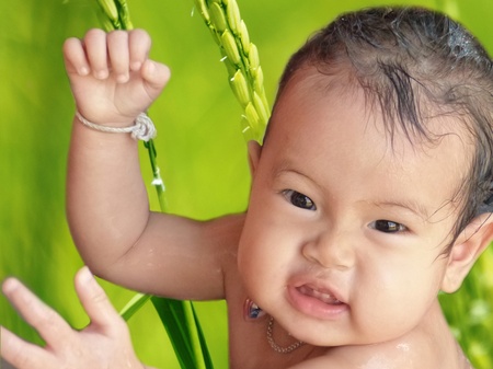 Baby girl among  bathing  fresh natureの写真素材