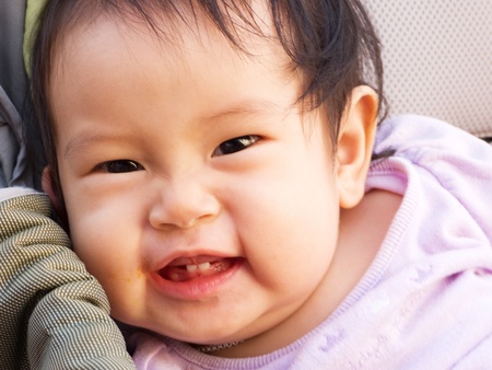 Smiling baby girl in the strollerの写真素材