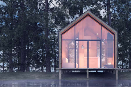 Secluded tiny house on the sandy shore of a lake with fog in a coniferous forest in cold cloudy lighting with warm light from the Windows. Stock 3D illustration.の写真素材