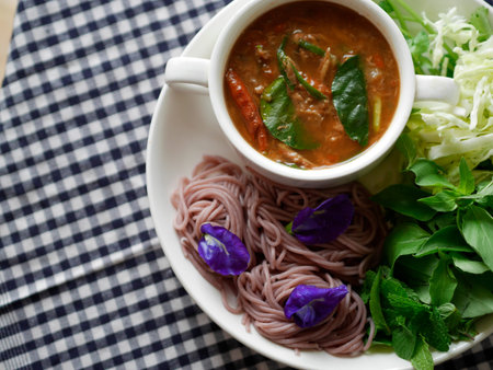 traditional thai noodle - Jungle curry is the combination of a minced fish and curry sauce on polka dot tableclothの写真素材