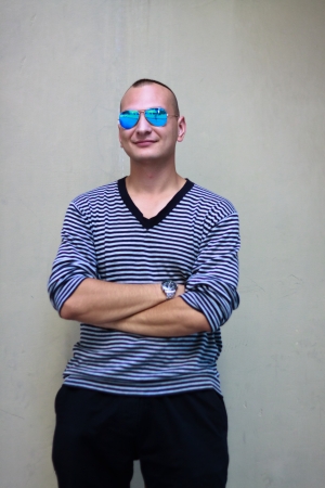 Portratit of smiling handsome man in stripped sweater and sun-glassesのeditorial素材