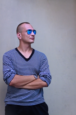 Portratit of handsome man in stripped sweater and sun-glassesのeditorial素材